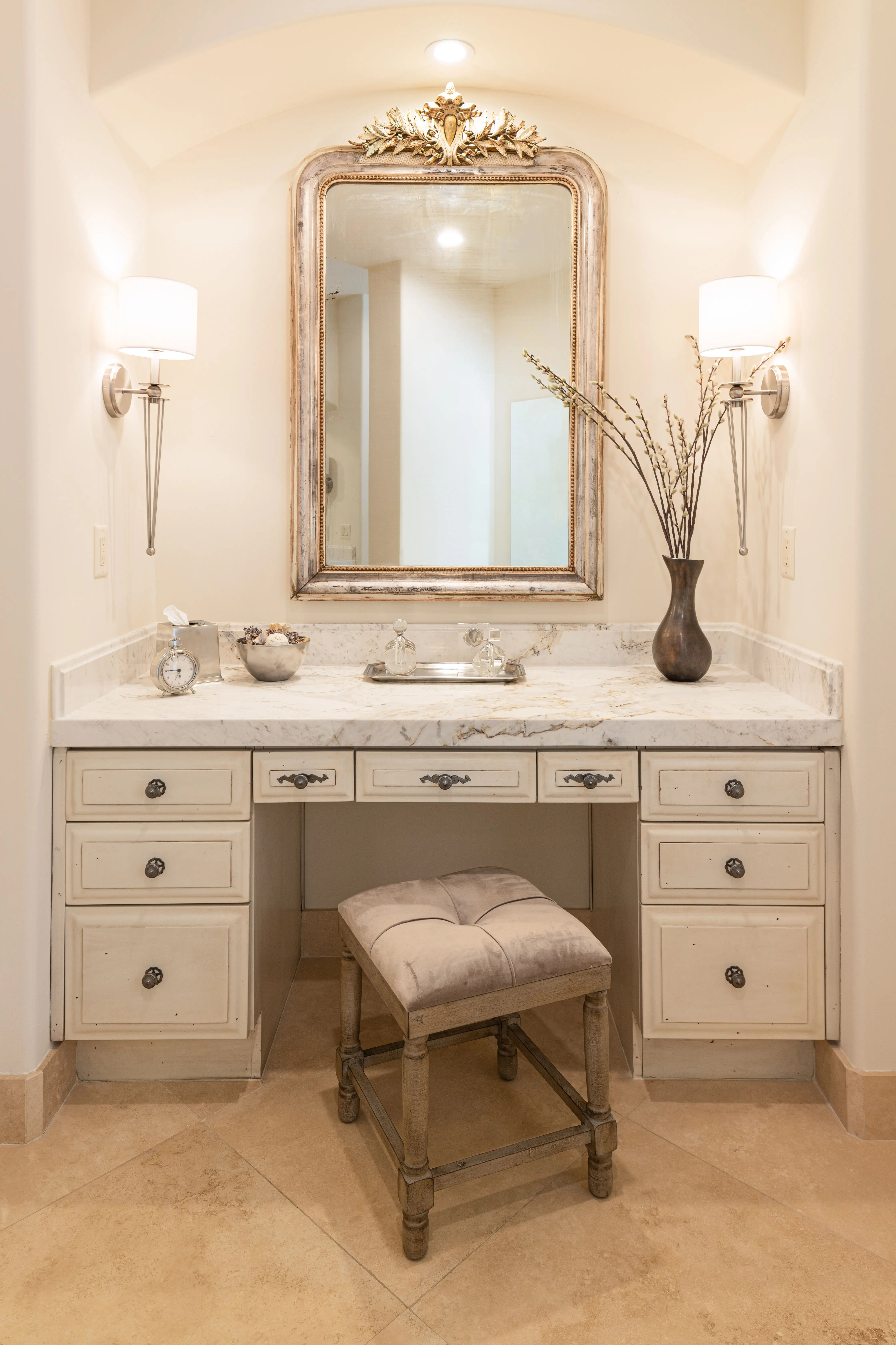 Primary bath vanity: antique gilt mirror, twin sconces and marble top